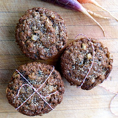 pear, carrot and coconut muffins on a wooden background, tied with string